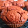 Close up of freshly baked keto chocolate muffins on a wire cooling rack.