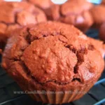 Close up of freshly baked keto chocolate muffins on a wire cooling rack.