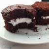 A delicious Keto Oreo Mug Cake with a rich, chocolatey flavor and creamy filling, served on a white plate beside a mug with ‘Have A Mug Cake’ written on it.