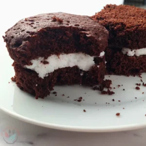 A delicious Keto Oreo Mug Cake with a rich, chocolatey flavor and creamy filling, served on a white plate beside a mug with ‘Have A Mug Cake’ written on it.