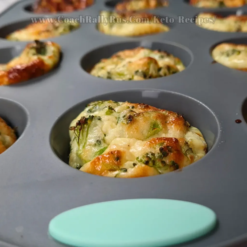 A tray of freshly baked cottage cheese egg muffins with pancetta, showing the golden-brown tops and visible bits of green herbs.