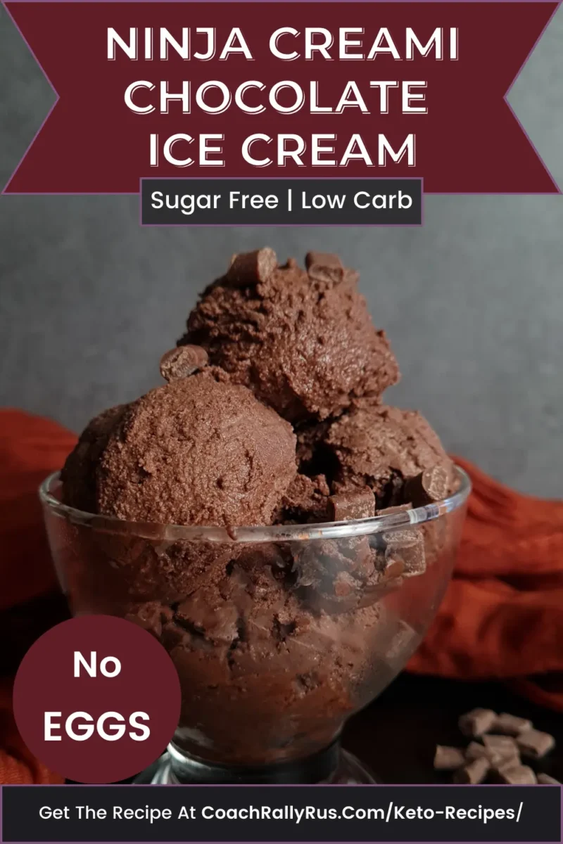 Ninja Creami Keto Chocolate Ice Cream A bowl of Ninja Creami Keto Chocolate Ice Cream, which is sugar-free and low carb, with a label stating ‘No Eggs’. The ice cream is presented in a clear glass bowl against a dark backdrop with an orange cloth underneath. Scattered chocolate pieces are visible around the bowl. The text at the bottom invites viewers to get the recipe at CoachRallyRus.com/Keto-Recipes.