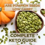 Question ‘Are pumpkin seeds low carb?’ above a bowl of green pumpkin seeds with an orange pumpkin in the background. Text reads ‘Complete Keto Guide’ with a link to CoachRallyRus.com/keto-recipes.