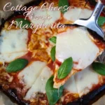 A close-up image of a Cottage Cheese Flatbread Pizza Margherita, showcasing a high-protein, keto-friendly meal. The pizza features golden-brown crust edges with melted mozzarella slices and vibrant green basil leaves on top of a rich tomato sauce.