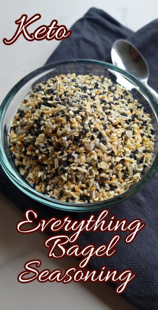 A clear glass bowl filled with Everything Bagel Seasoning on a dark surface.