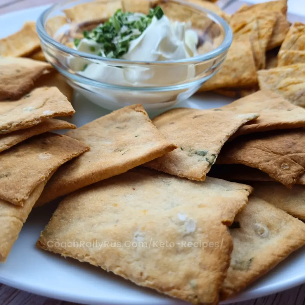 3-Ingredient Keto Crackers on a wooden board with a small bowl of dip