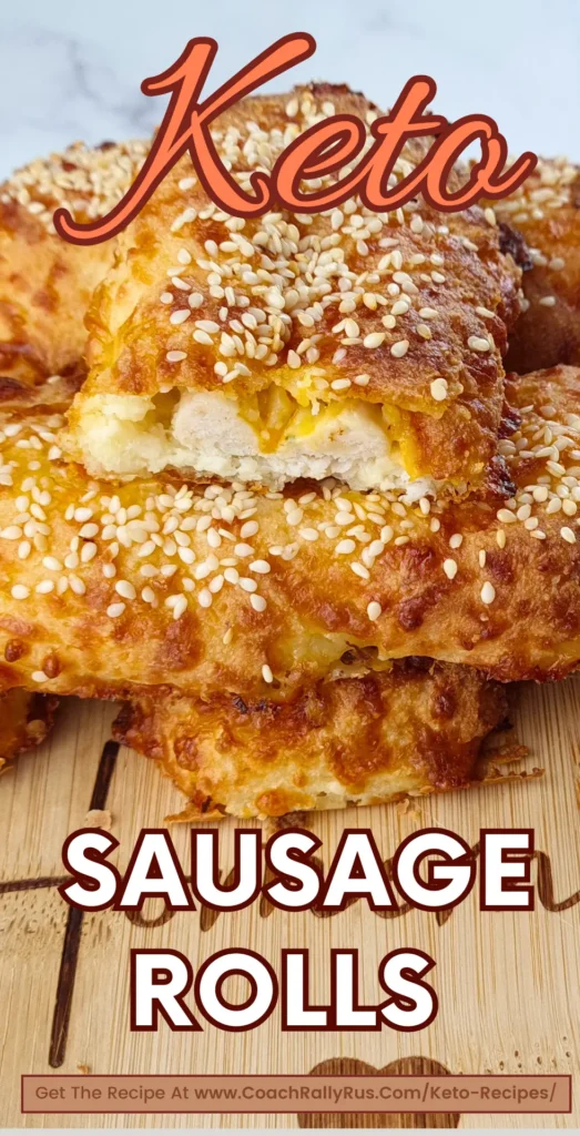 Keto sausage rolls with sesame seeds on a wooden board, sliced to show the sausage filling.