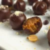 Keto Chocolate Peanut Butter Cottage Cheese Bonbon with a bite taken out, showing the creamy peanut butter filling.