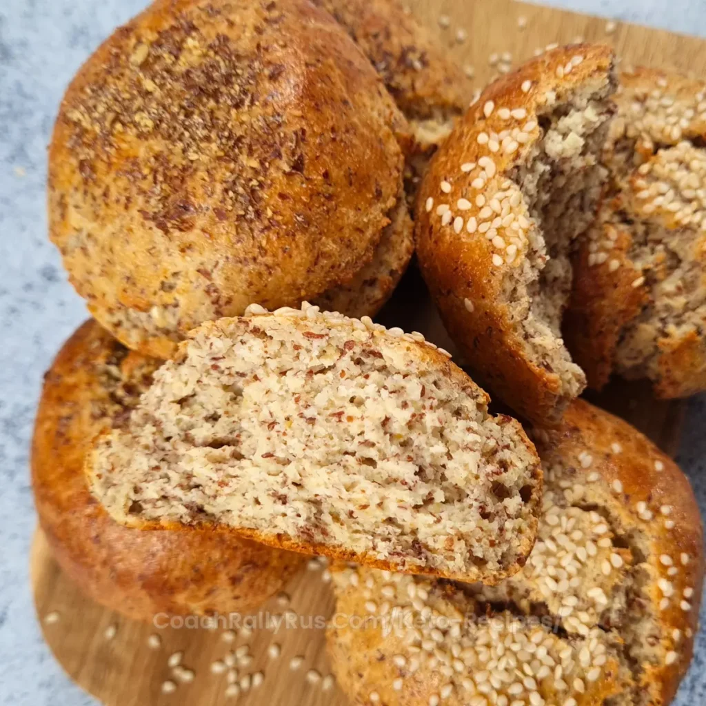 A sliced keto flaxseed cottage cheese bread roll showing soft, fluffy texture with flaxseed and almond flour.