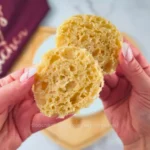 Hand holding fluffy slices of keto mug bread