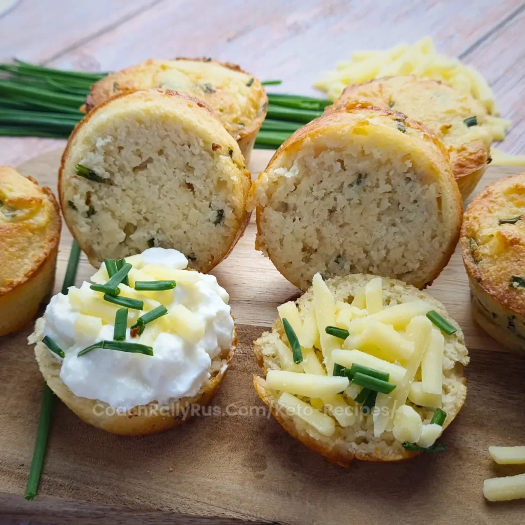 A sliced keto cottage cheese biscuit topped with shredded cheese and cottage cheese.
