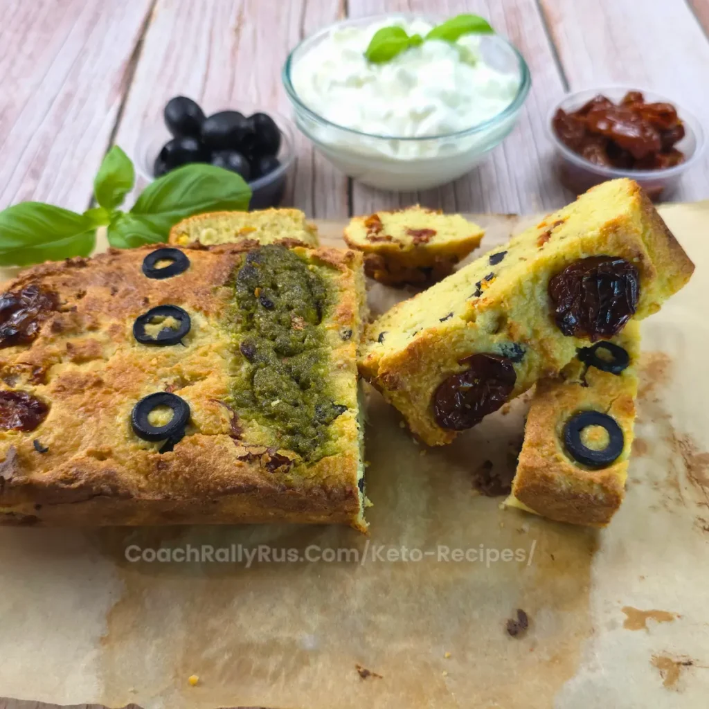Close-up of keto sun-dried tomato and olive cottage cheese bread served with cottage cheese, olives, and basil.