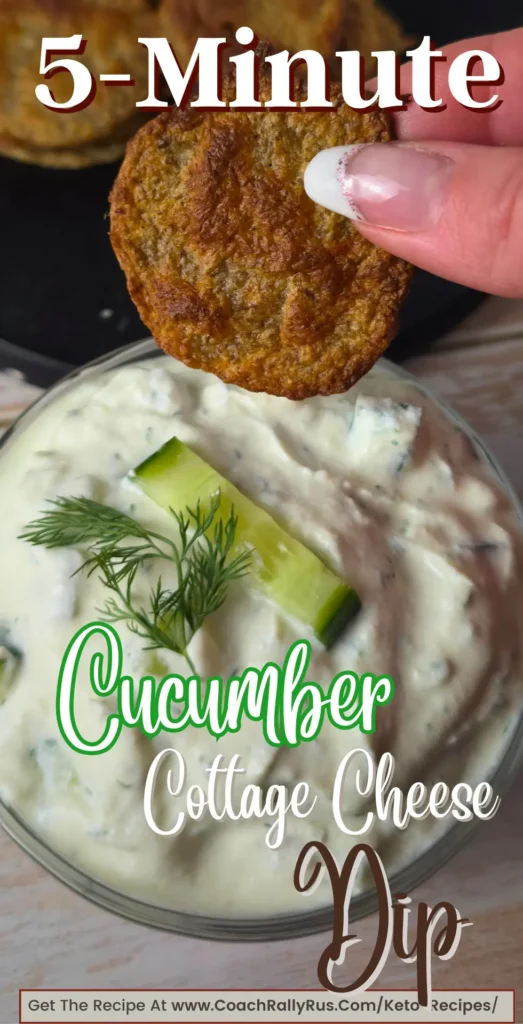 A creamy bowl of dill cucumber cottage cheese dip, garnished with fresh cucumber and dill, with a crispy keto cracker being dipped.