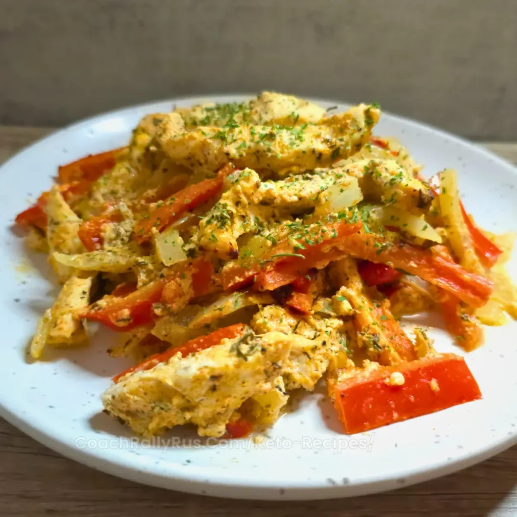 Oven-baked keto chicken gyro casserole with red bell peppers and onions.