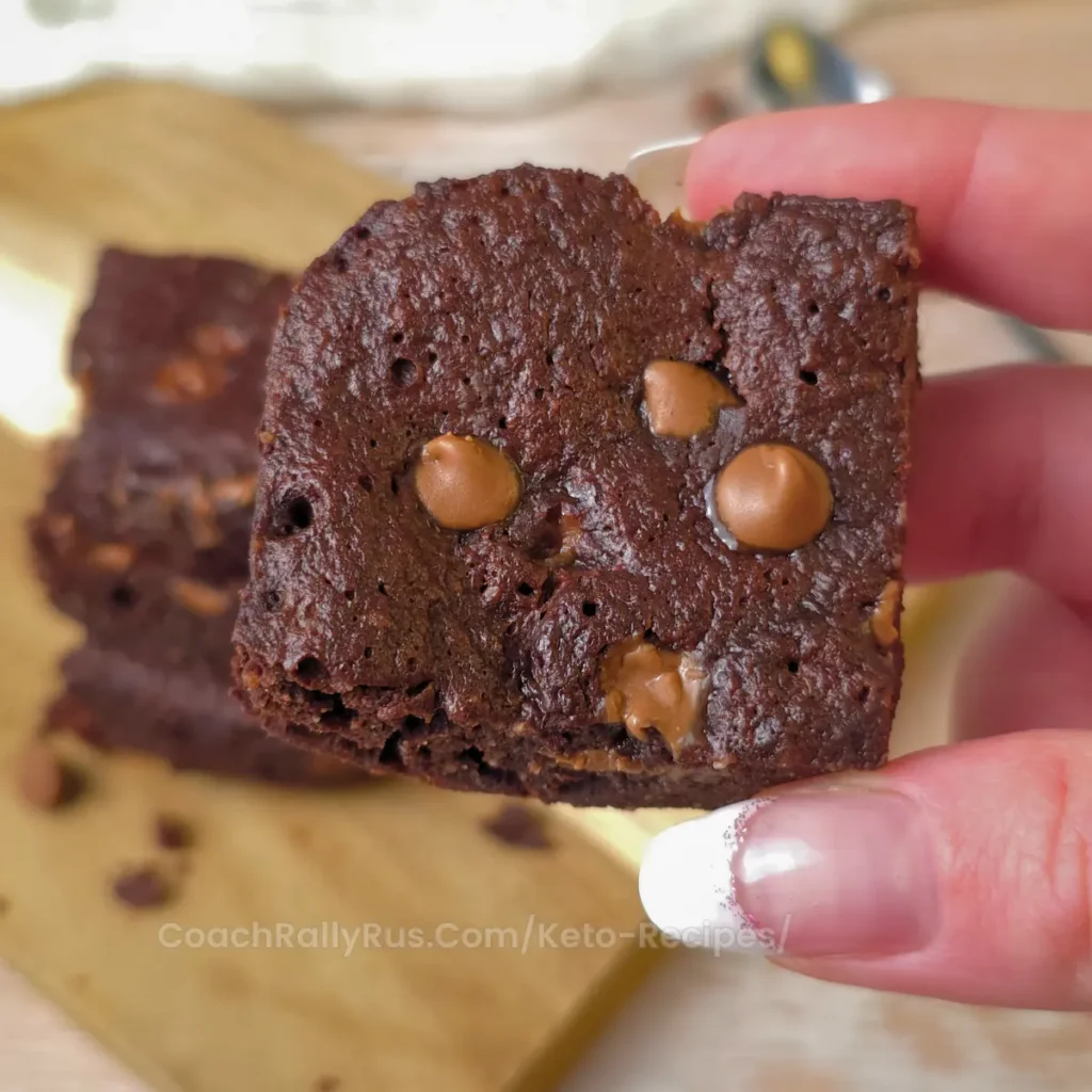 A close-up of a keto cottage cheese brownie with chocolate chips.