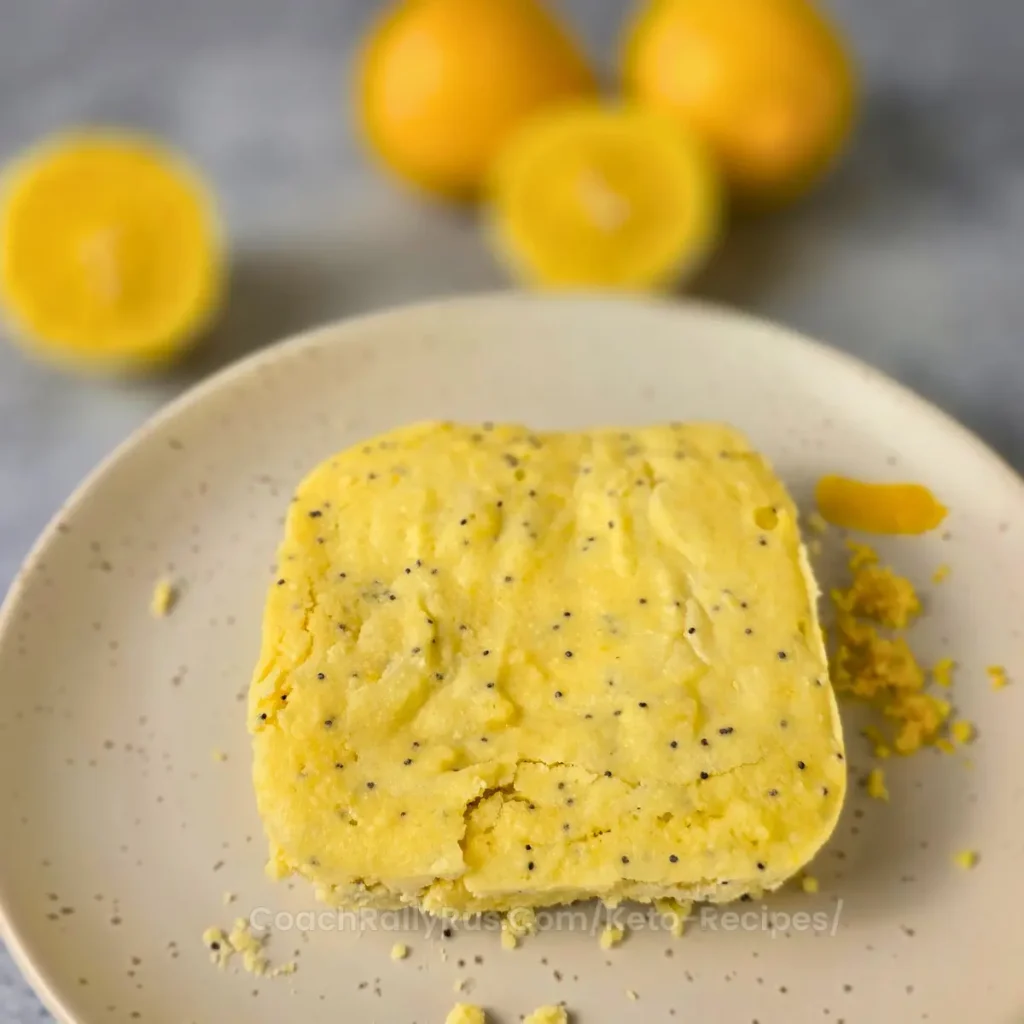 Baked keto lemon bread with poppy seeds on a ceramic plate