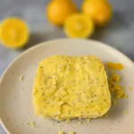 Baked keto lemon bread with poppy seeds on a ceramic plate