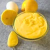 close-up of spoonful of keto lemon curd with lemons