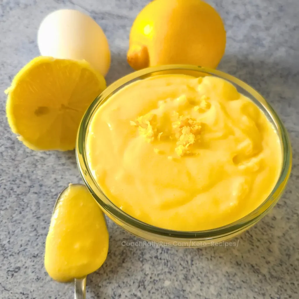 close-up of spoonful of keto lemon curd with lemons