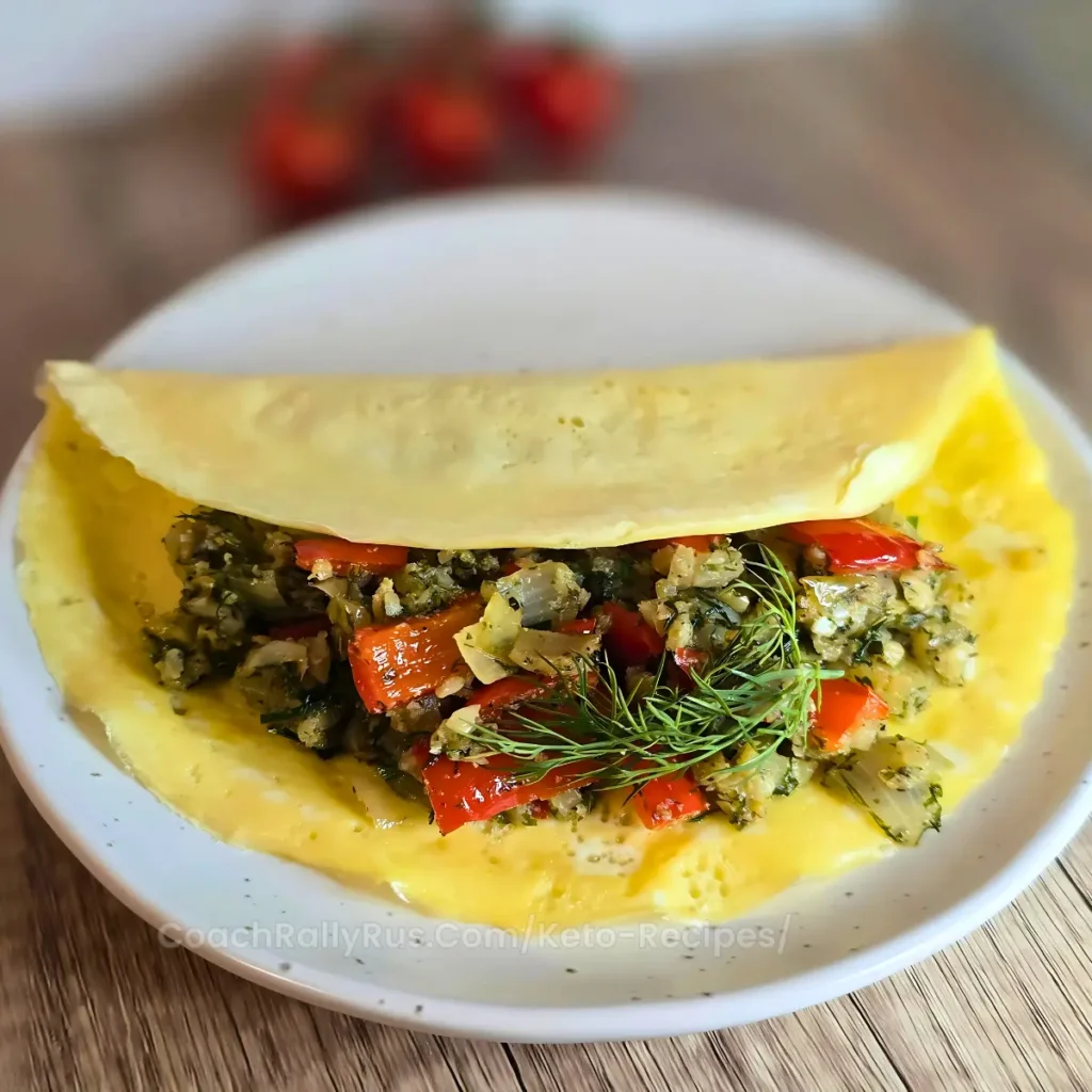 Mediterranean keto omelette with cauliflower rice, peppers, onions, and fresh dill on a white plate.