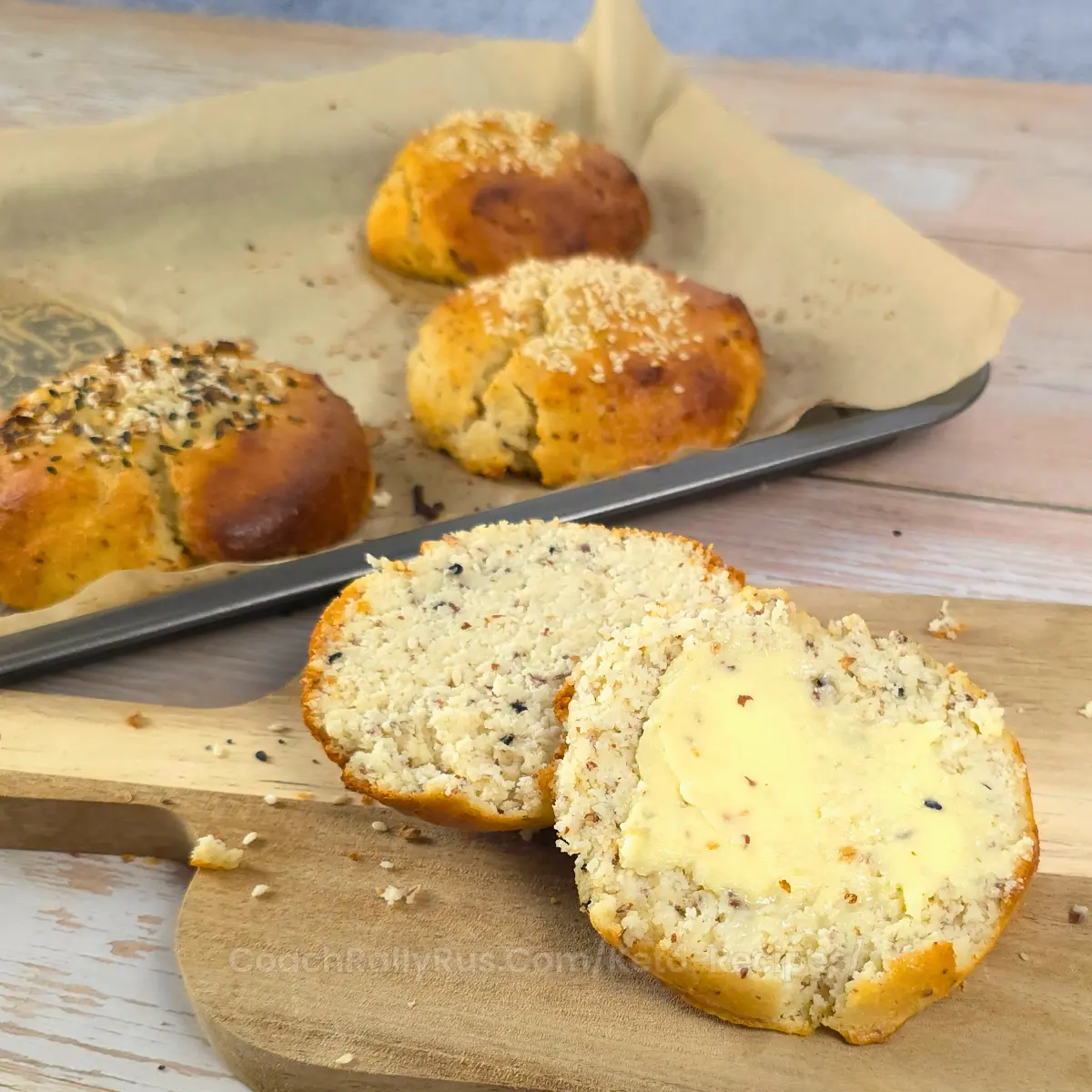 Egg free cottage cheese keto burger buns sliced with butter spread on top.