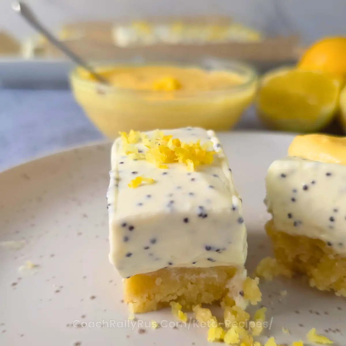 Lemon poppy seed bar topped with lemon curd and zest on almond flour crust.