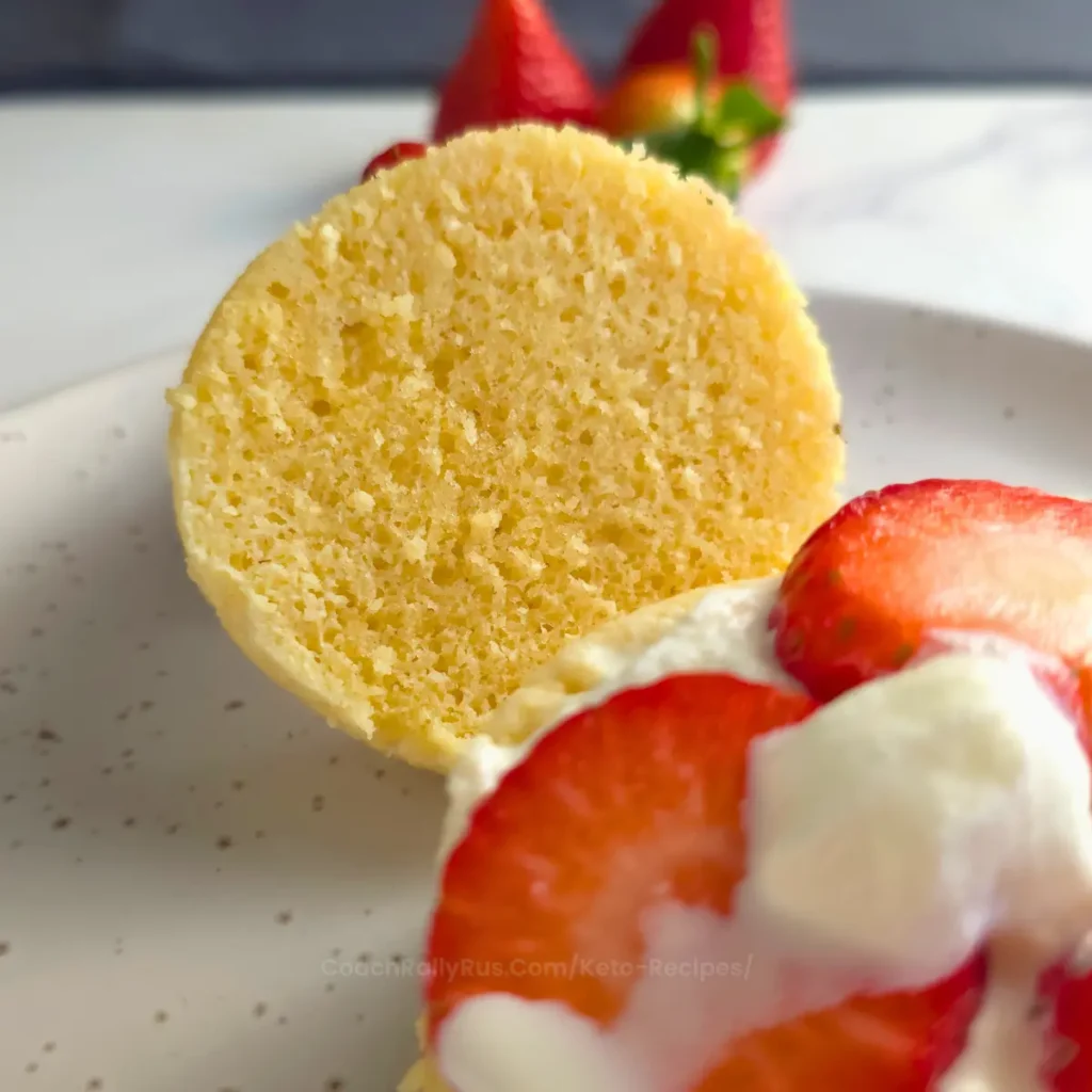 almond flour mug cake sliced with fresh strawberries