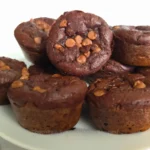Stack of cottage cheese keto chocolate brownie muffins on a white plate