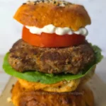 Juicy keto Mediterranean burger on a bun with lettuce, tomato, and mayo