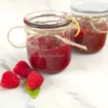 Jars of raspberry chia jam decorated with twine