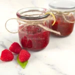 Jars of raspberry chia jam decorated with twine