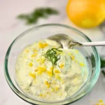 Creamy keto lemon dill cottage cheese sauce in a glass bowl with fresh dill and lemon zest