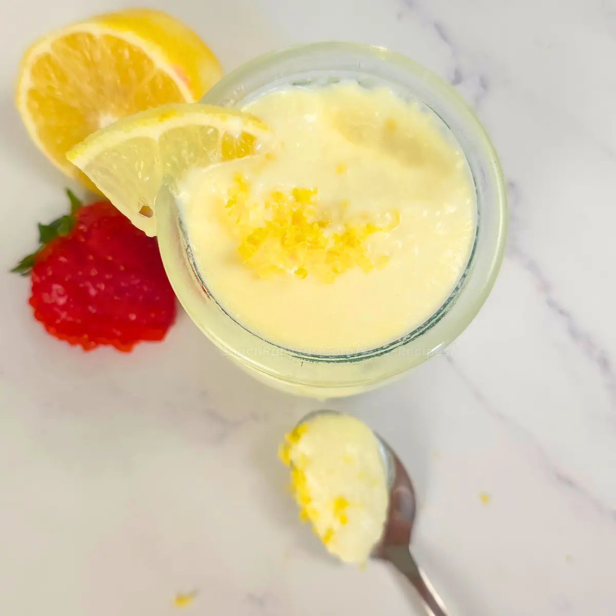 keto lemon fluff in a jar with spoonful of fluff and lemon zest