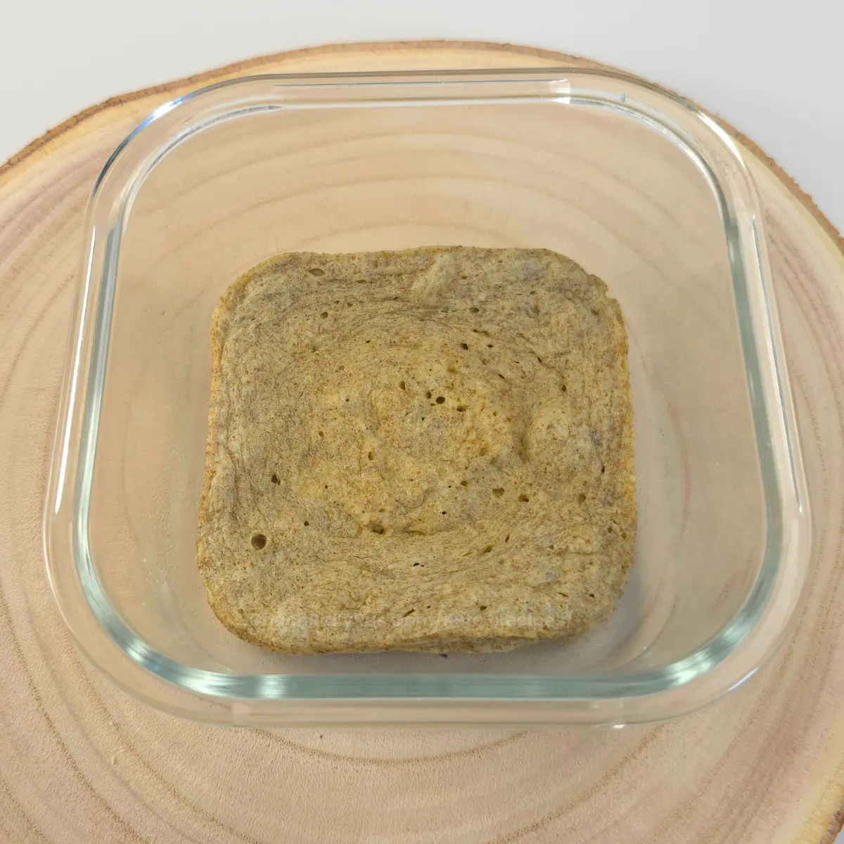 Keto chia mug bread in glass container on wood background