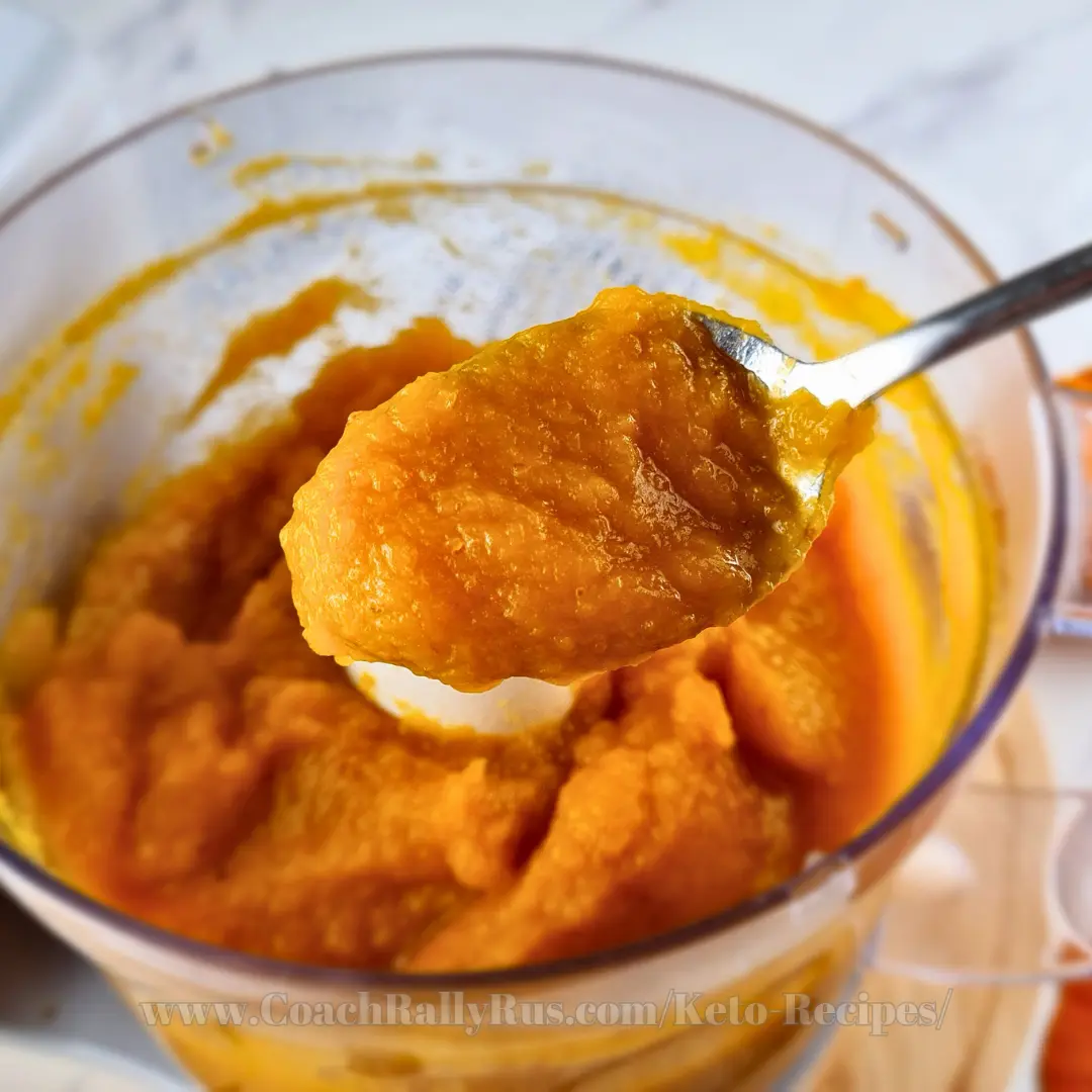 Spoonful of fresh homemade pumpkin puree in a blender bowl