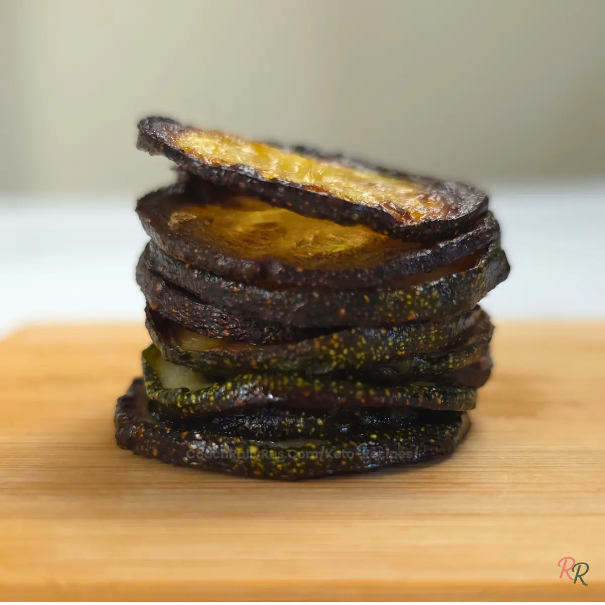 Stack of plain baked zucchini chips without seasoning