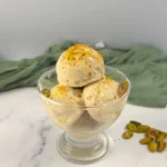 Creamy keto pistachio ice cream made with cottage cheese, served in a sundae glass.