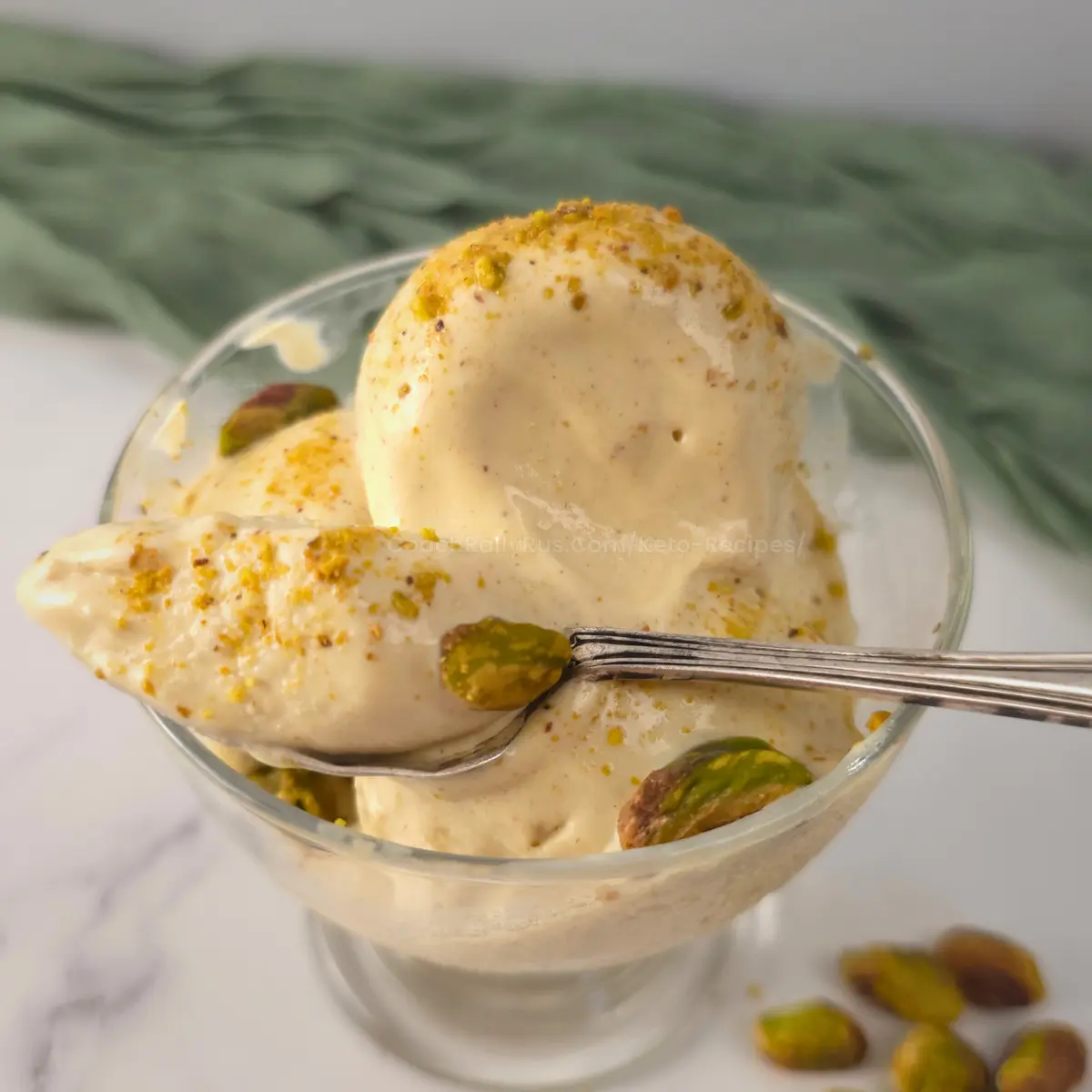 Spoonful of creamy pistachio cottage cheese ice cream with chopped pistachios.