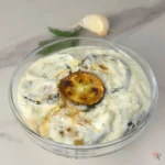 Creamy zucchini and garlic dill yogurt dip with visible zucchini slices and fresh dill, close-up shot