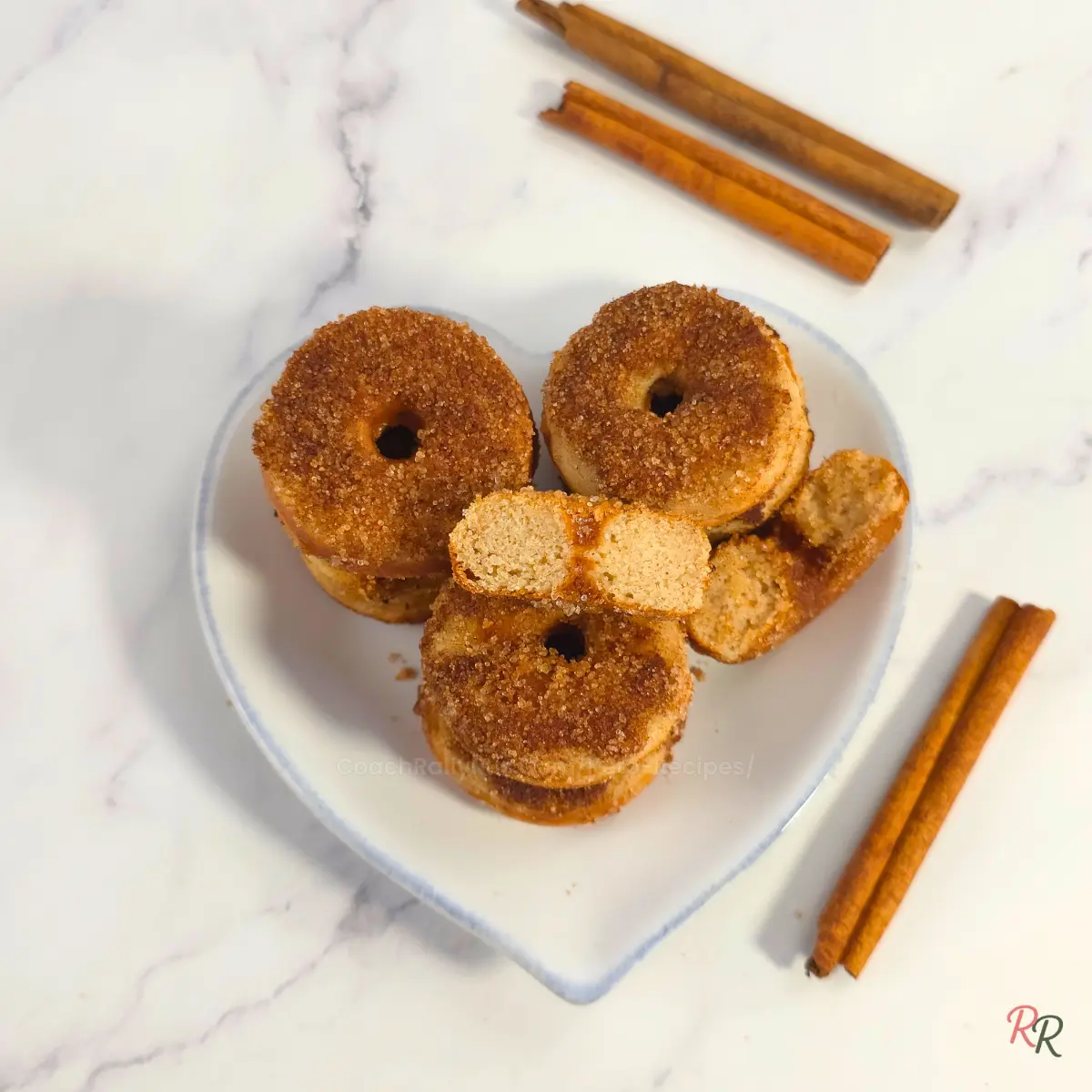 Heart-shaped plate with cinnamon sugar keto donuts by Rally Rus.