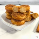 eto donuts stacked with one halved to reveal center, by Rally Rus.