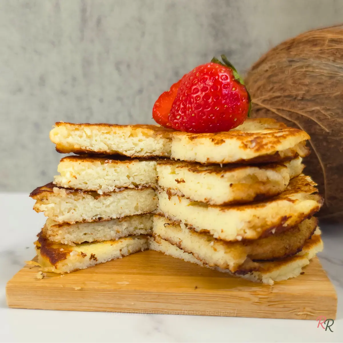 Cross-section view of fluffy low carb pancakes with strawberry on top