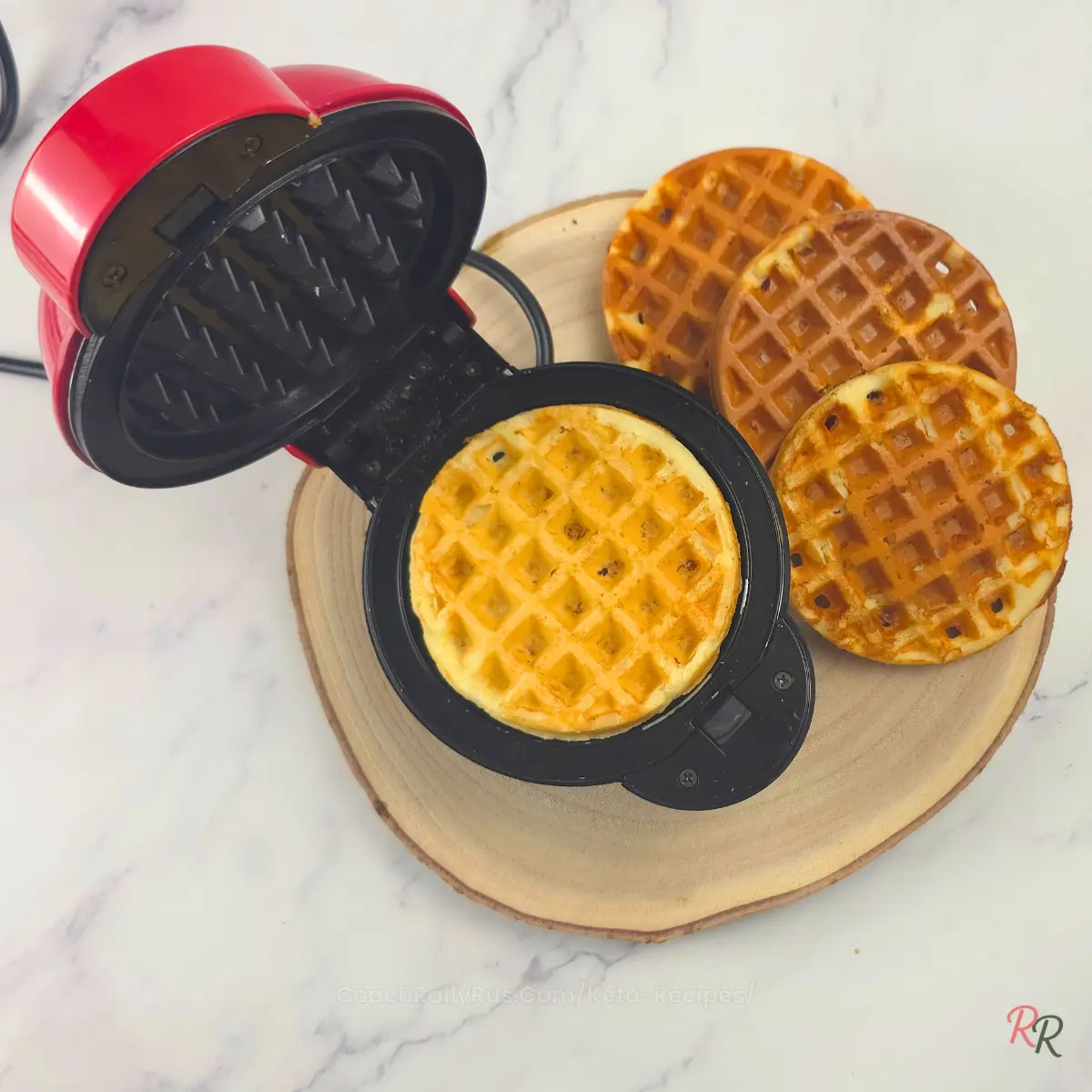 Freshly cooked keto waffles with almond flour inside a waffle maker by Rally Rus