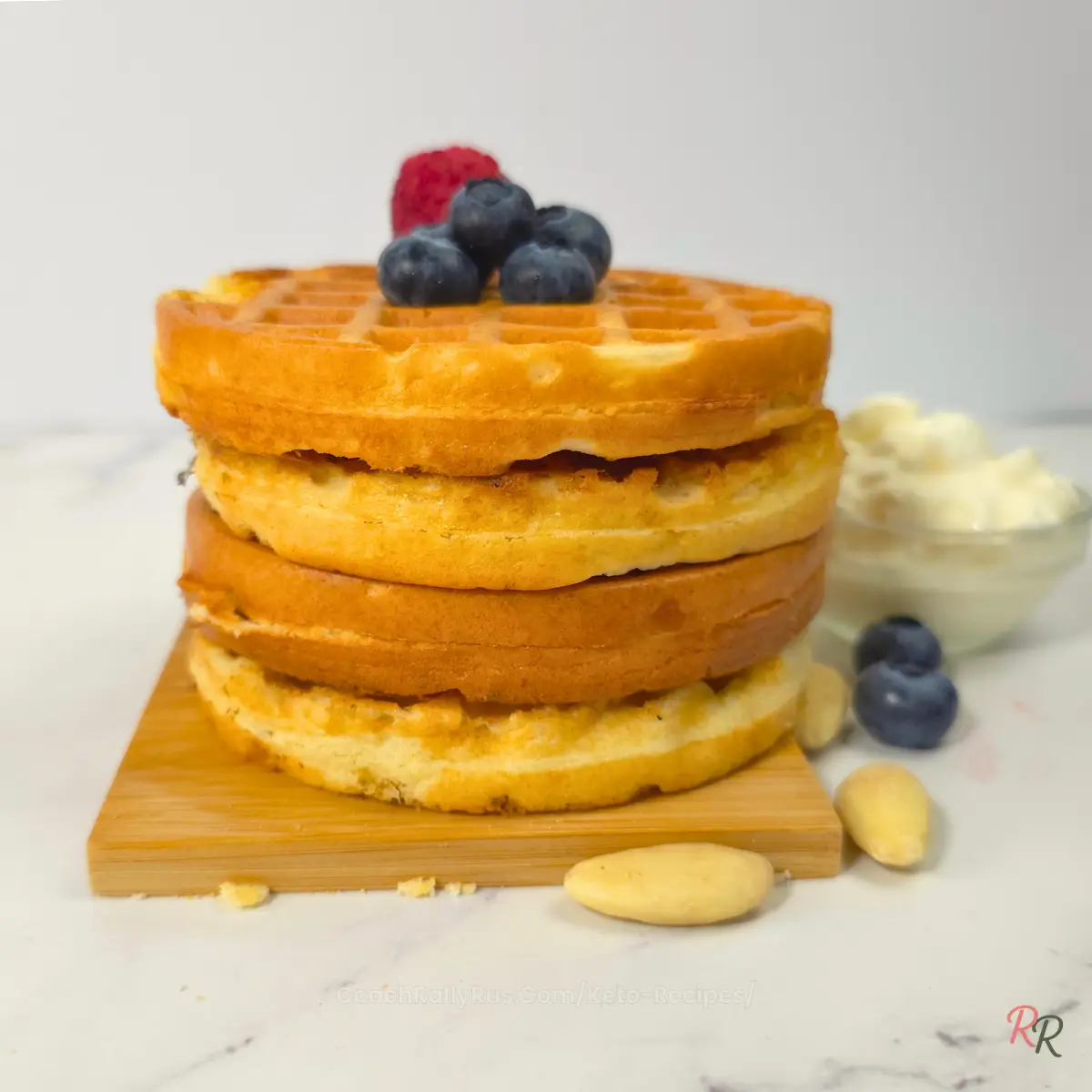 Stack of fluffy keto cottage cheese waffles with blueberries on top by Rally Rus