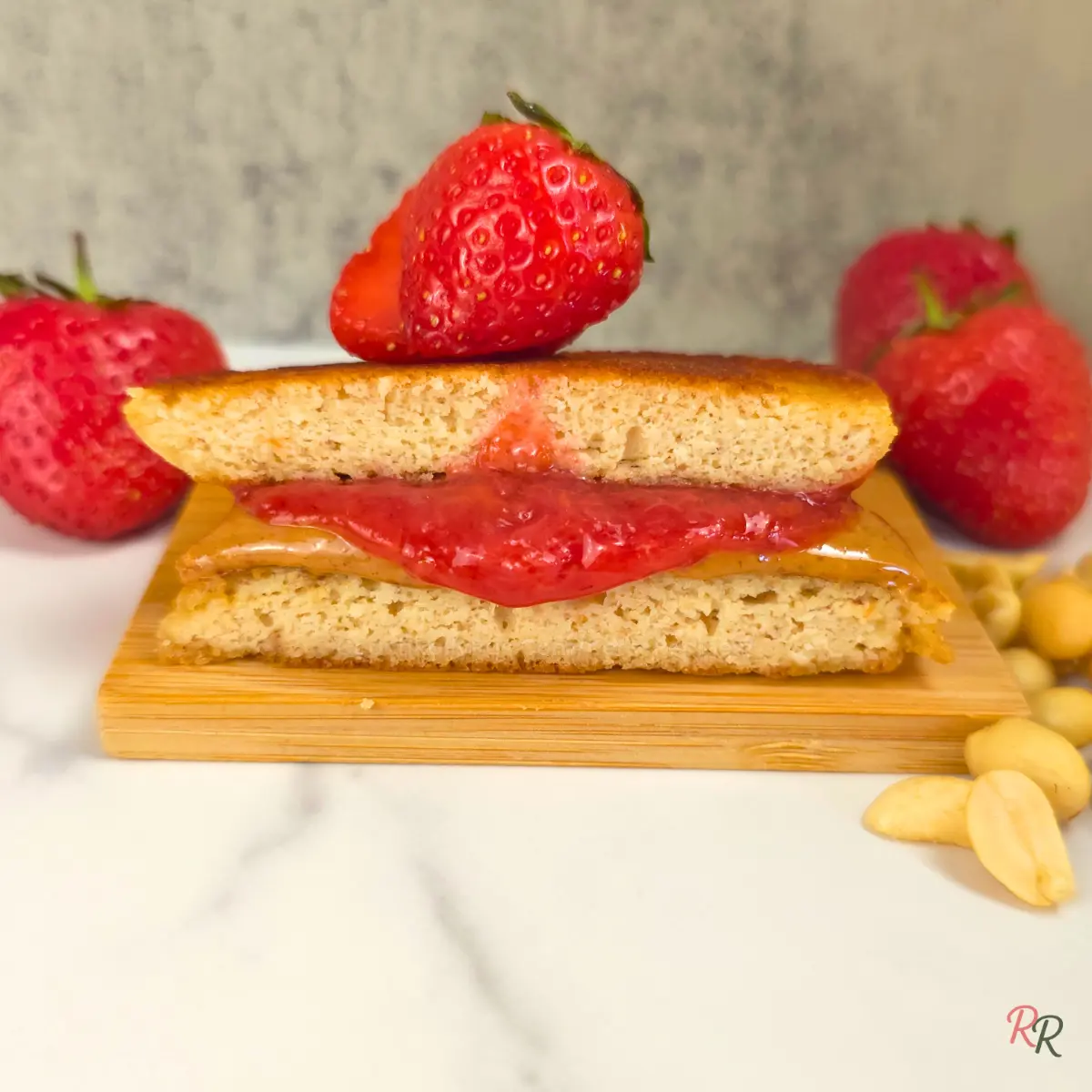 Keto peanut butter and jelly pancake sandwich with strawberry topping