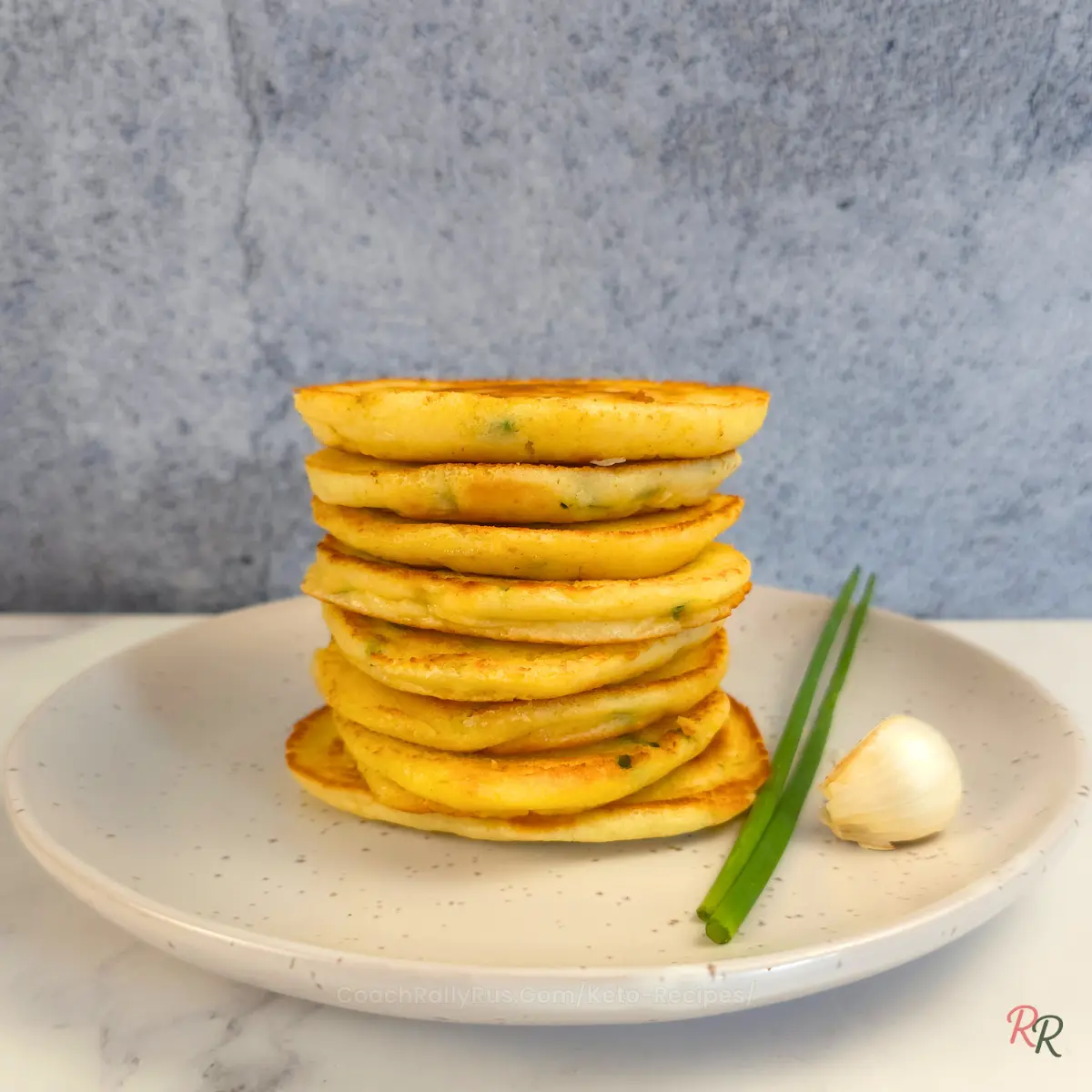 Tower of keto pancakes stacked on white plate