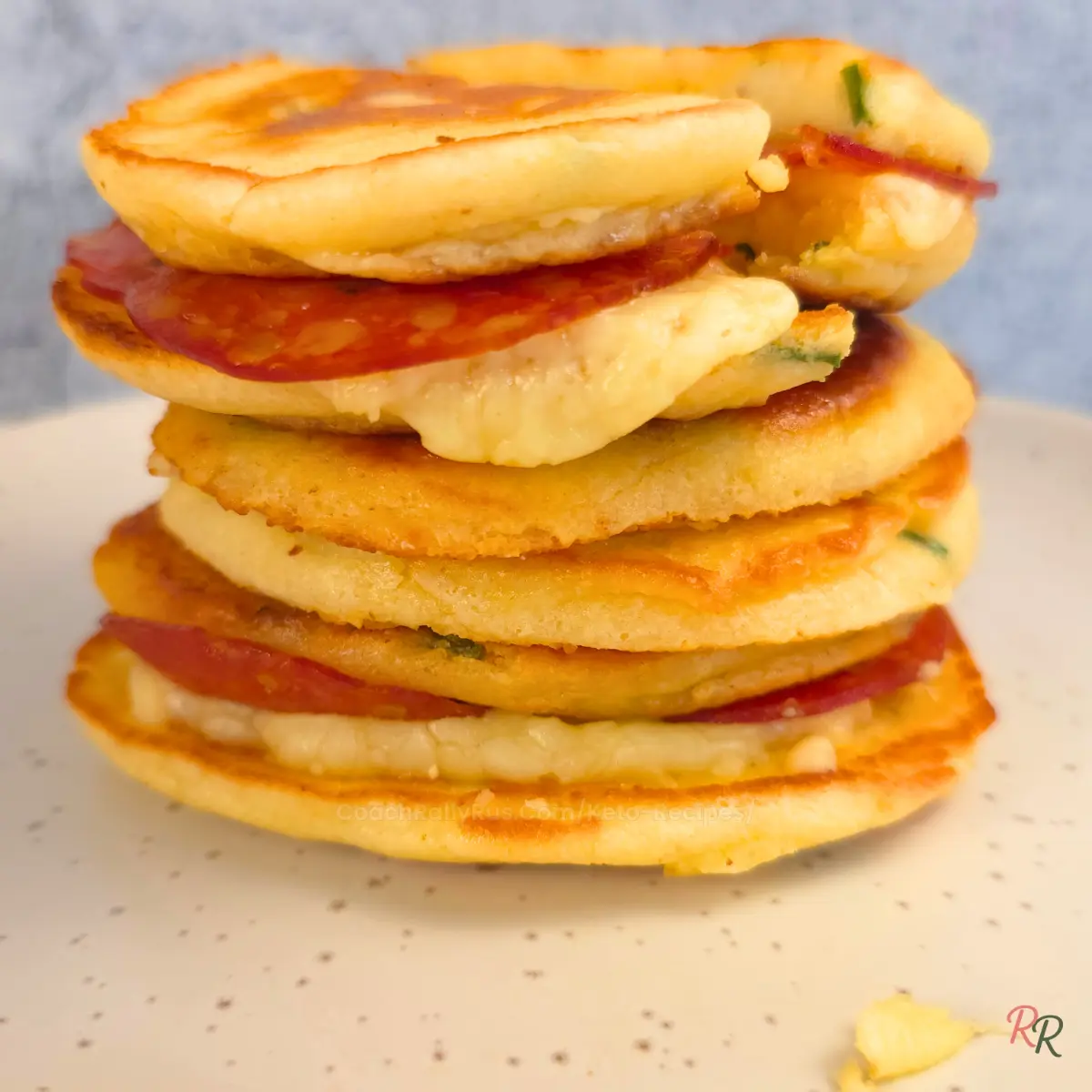 Tower of keto pancake sandwiches stacked on white plate