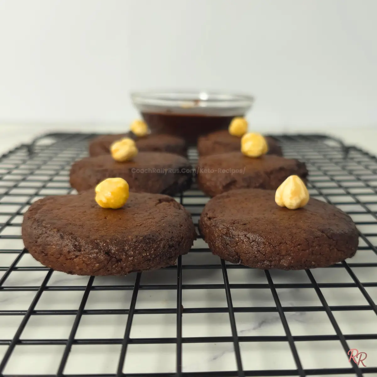 Cooling Keto Nutella Cookies – Easy 3 Ingredient Recipe Freshly baked 3 ingredient keto Nutella cookies cooling on wire rack