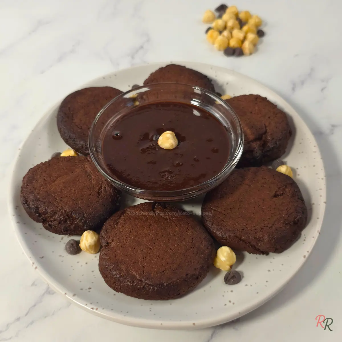 Easy Low Carb Nutella Cookies with Hazelnut Spread Keto Nutella cookies on plate with chocolate hazelnut spread bowl