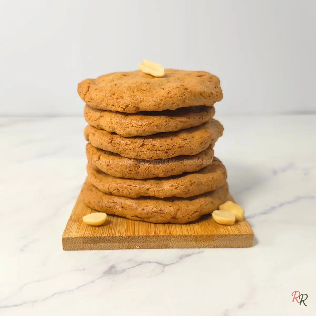 Low Carb Peanut Butter Cookies Recipe – Easy 3 Ingredient Version Stack of flourless keto peanut butter cookies on wooden board.